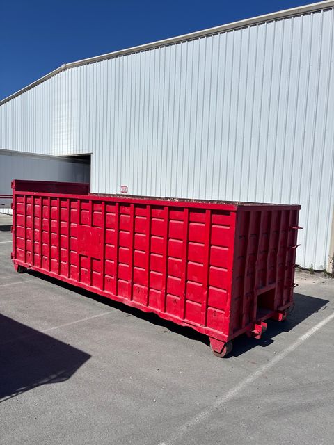 Red Heverly & Sons 40-yard roll-off dumpster staged at a San Diego warehouse